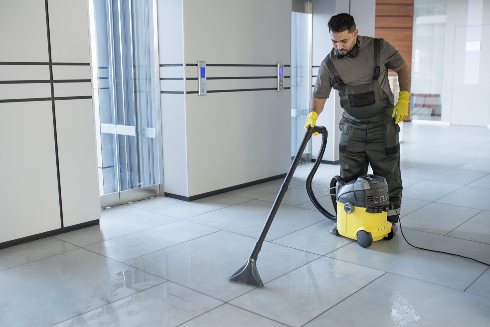 Cleaning operative with industrial vacuum cleaning commercial premises