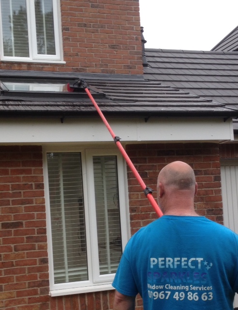 Perfect Sparkles operative using ladderless water-fed pole for window cleaning