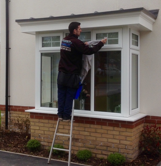 Perfect Sparkles operative cleaning windows on a new build home